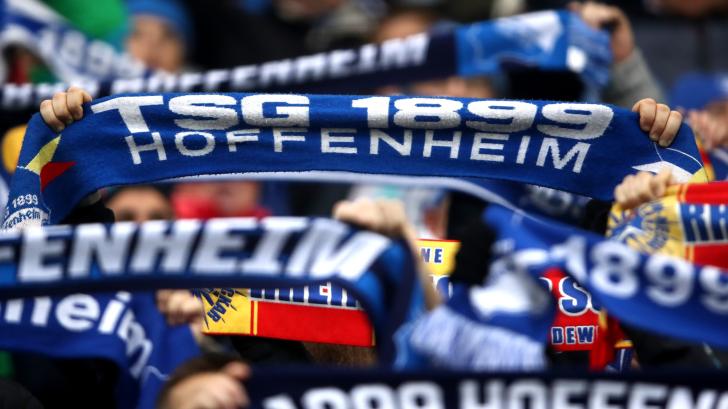 Hoffenheim fans hold up scarves at a game in the Bundesliga